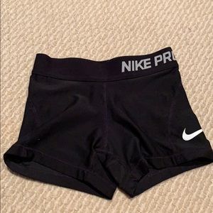 A pair of black nike pros